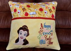 a pillow that is sitting on top of a brown leather couch with an image of snow white and the seven dwarfs printed on it