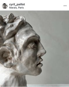 a white marble sculpture of a man's head