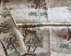 two pieces of fabric with birds and flowers on them