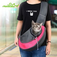 a woman is holding a cat in her sling bag that says, i need you