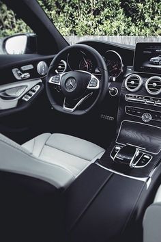 the interior of a mercedes c - class car with dashboard, steering wheel and center console