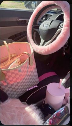 the interior of a car with various items in it, including a purse and cup