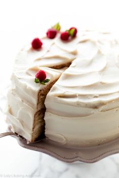 a cake with white frosting and strawberries on top