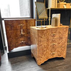 two wooden dressers sitting next to each other on top of a hard wood floor