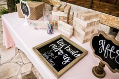 a table topped with lots of wooden blocks and chalkboard signs next to each other