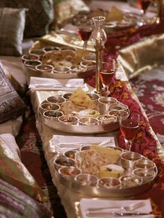 a long table filled with lots of food on top of it's trays