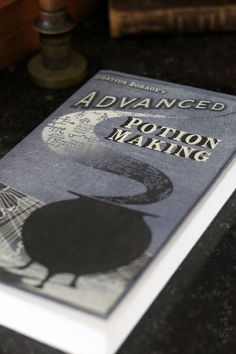 a book sitting on top of a table next to an open book with the title advanced potton making