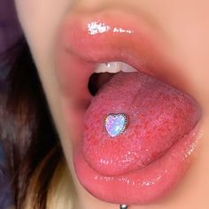 a close up of a person's tongue with a heart on it