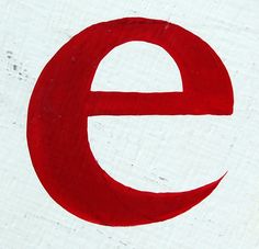 a close up of a red and white sign with the letter e in it's center