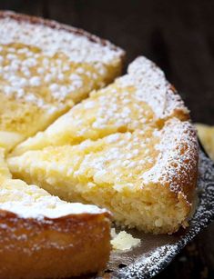 a close up of a cake on a plate with powdered sugar