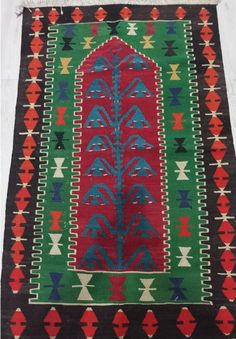 an old rug with colorful designs on it