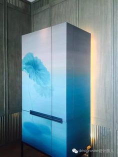 a large blue refrigerator sitting in the middle of a room