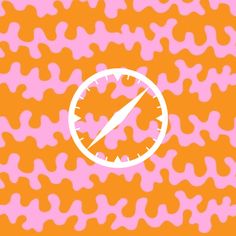 an orange and pink wallpaper with a white clock on it's face in the center