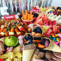 a table filled with lots of different types of foods and desserts on top of it