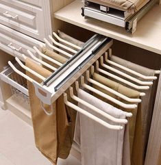 an over the door drying rack in a kitchen with towels hanging from it's sides