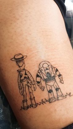 a tattoo on the leg of a person wearing a cowboy hat and holding an arm