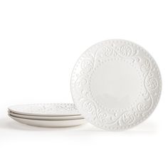 three white plates sitting next to each other on top of a white tableware set