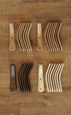 several wooden combs are lined up on a table