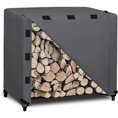 a large pile of logs sitting in front of a gray box with black handles and sides