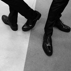 black and white photograph of two men in dress shoes