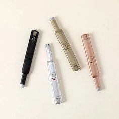 three different types of electronic devices on a white surface with one lighter and the other pen