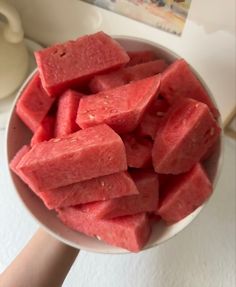 a bowl full of watermelon cut into cubes