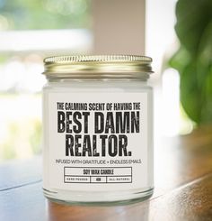 a candle that is on top of a table with the words best damn realtor