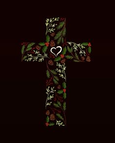 a cross decorated with holly, pine cones and a white heart on it's side