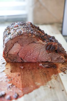 a piece of meat sitting on top of a wooden cutting board