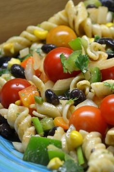 a blue plate topped with pasta salad and chicken