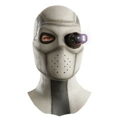 a person wearing a white mask with two eyes and one eye has an object in it's mouth