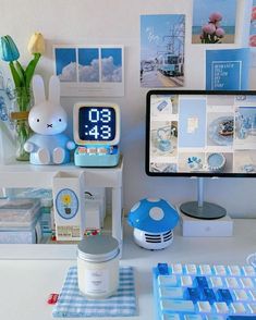 a desk with various items on it including a clock, keyboard and mouse