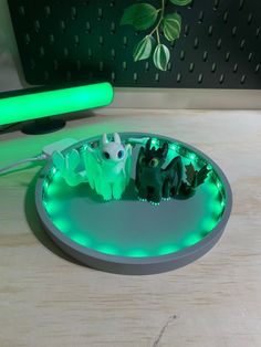 a green light is on in the shape of a bowl with two small figures inside