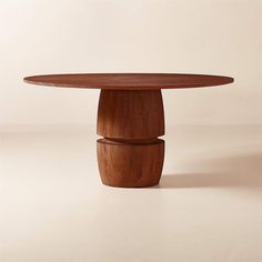 a round wooden table with two pedestals on each side