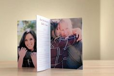 an open photo book on a table with the pages folded in half to show a couple hugging