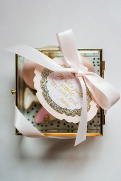 a box with some cookies in it and a pink ribbon on the top that says happy mother's day