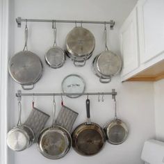 pots and pans are hanging on the wall