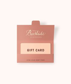 a pink gift card sitting on top of a white table