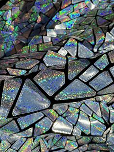 a close up view of some kind of glass mosaic pattern on a surface with holographics