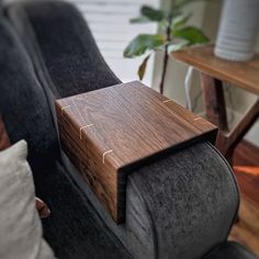 a wooden table sitting on top of a gray couch