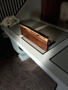 a wooden box sitting on top of a white table