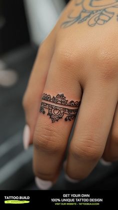 a woman's hand with a tattoo on it and a ring in the middle