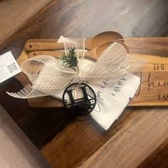 a couple of wooden utensils sitting on top of a table next to a sign