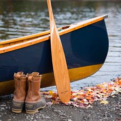 a pair of brown boots sitting next to a blue and yellow boat