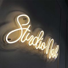 a neon sign on the wall that says studio hot in white letters, and is lit up