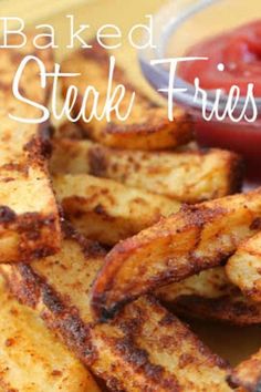 baked steak fries on a plate with ketchup and tomato sauce in the background