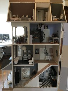 a doll house with all the furniture and accessories in it, including stairs to the second floor