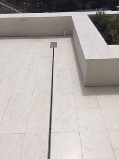 an outdoor area with concrete blocks and plants