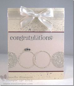 congratulations card with two bracelets and a bow on the front, in silver glitter