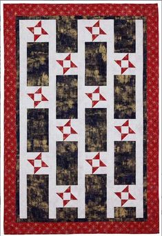 a quilted wall hanging with red and black squares on the bottom, along with an arrow design